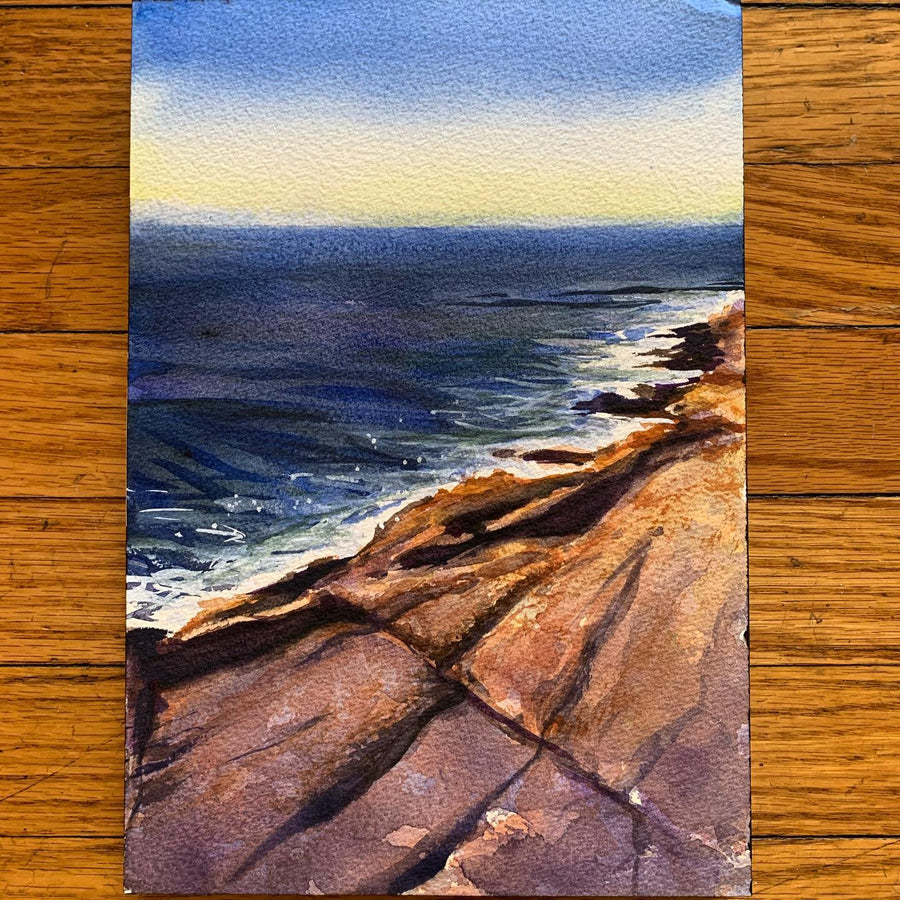 watercolor rocky coastline at sunset