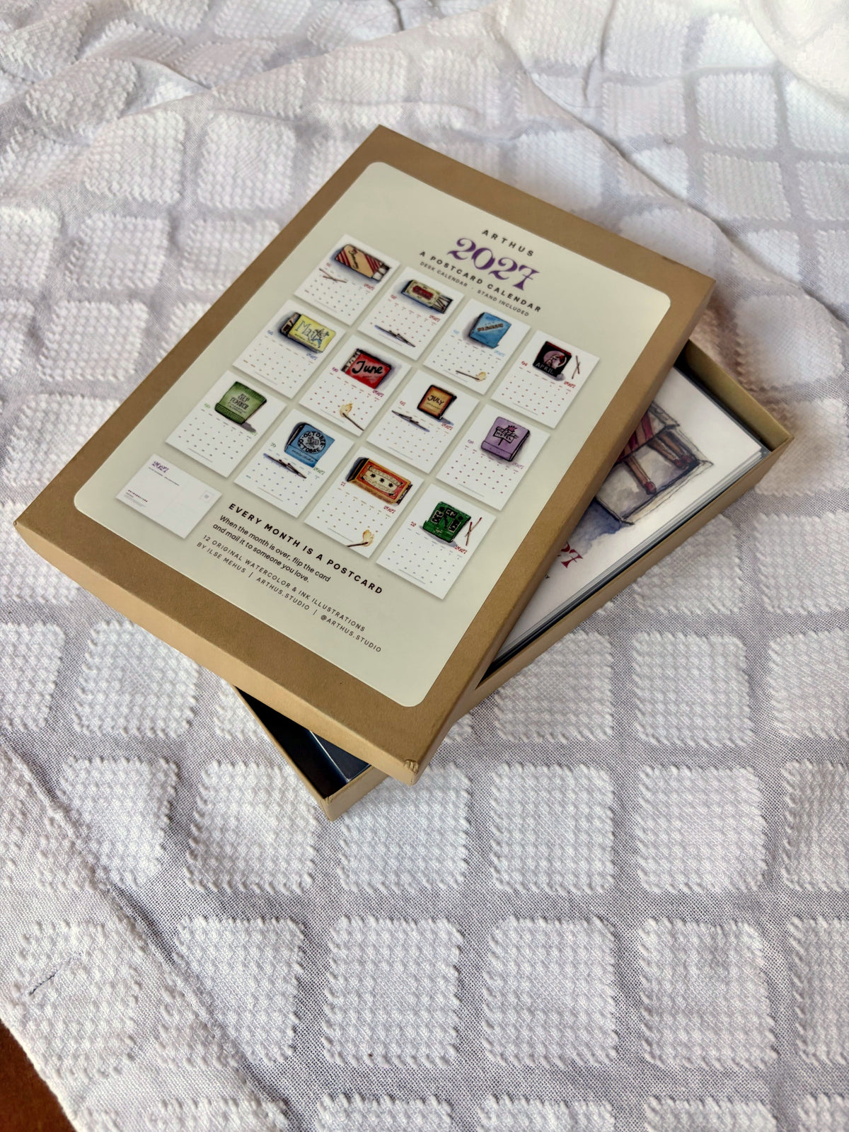 2027 postcard calendar box with lid lifted, postcards inside