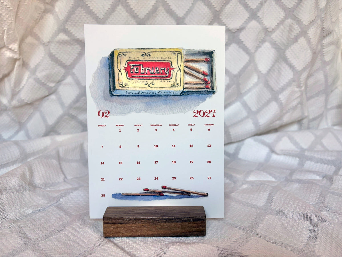 arthus 2027 postcard desk calendar, february watercolor matchbox on a walnut wood stand