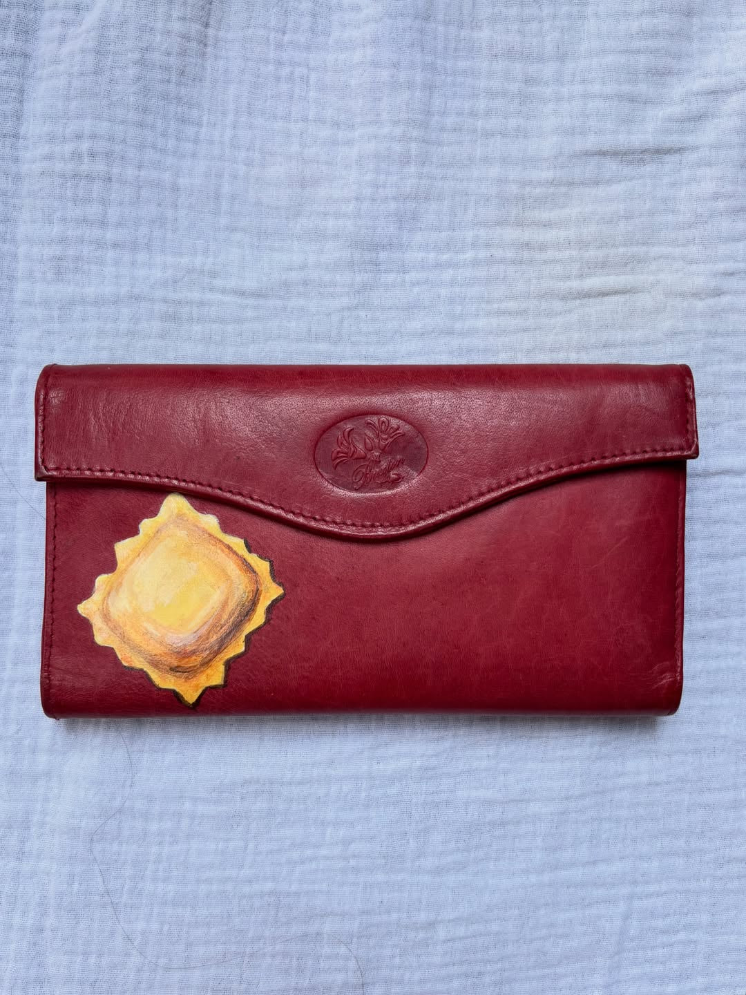 ravioli hand-painted on a vintage red buxton leather bifold wallet
