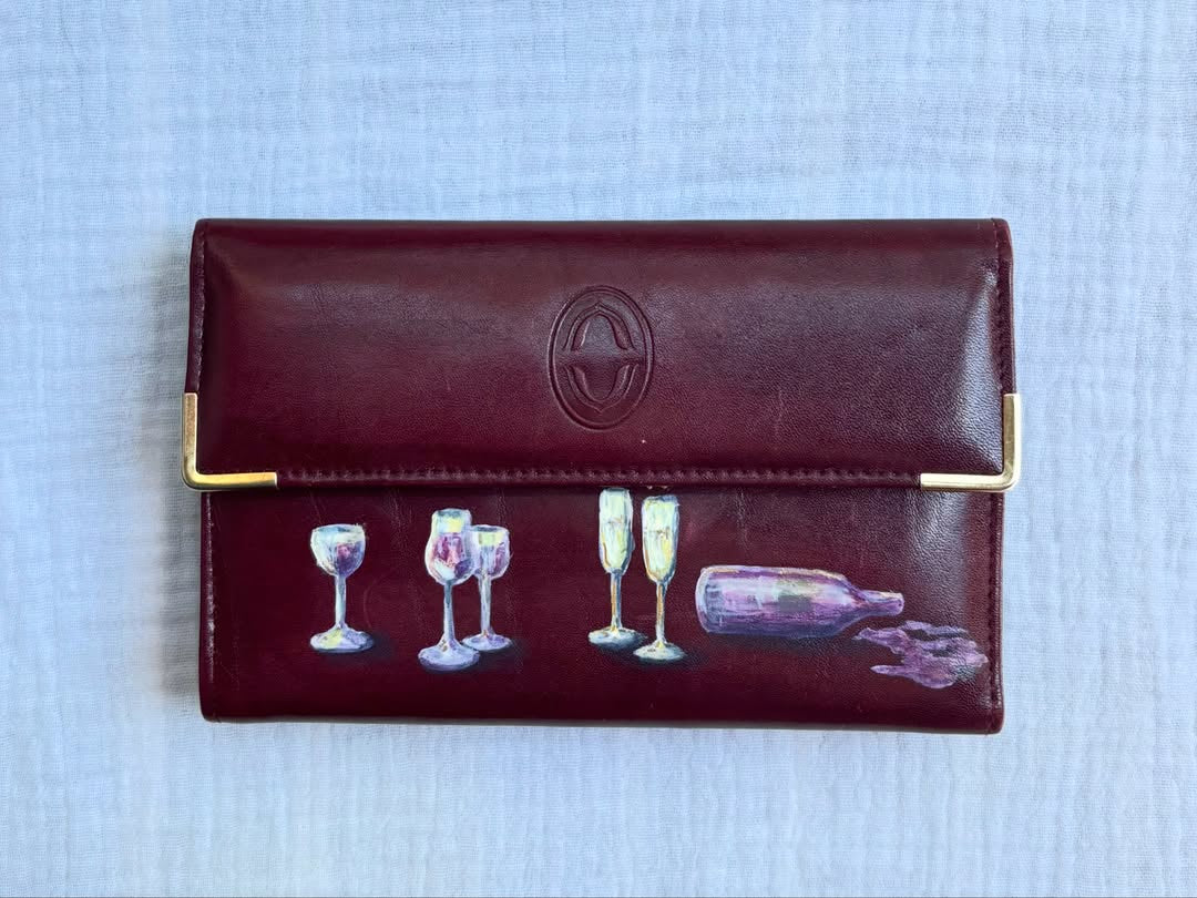 wine glasses, champagne flutes, and a bottle hand-painted on a vintage burgundy buxton leather clutch wallet